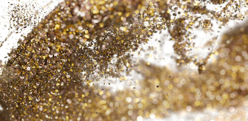 Sparkling gold and bronze glitter explosion. Festive background for holidays, celebrations, and luxury branding.