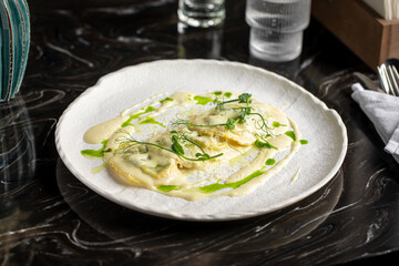Portion of italian ravioli dumplings dish with creamy sauce