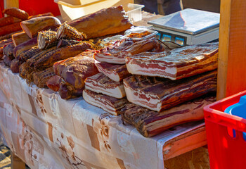 Organic homemade cured dry bacon sold on a local market stall
