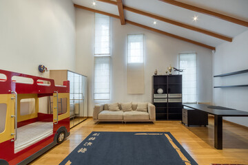 Stylish children's room with high ceiling and furniture. Original bunk bed in the form of a bus.