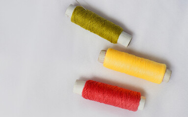 Many colorful sewing threads falling on white background. Selective focus. Abstract Images.