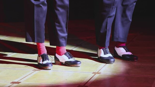 Couples dancing retro jazz swing and lindy hop, dancing suede shoes view, dancers in a ballroom club wooden floor, female and male dancing evening night, dance performance rehearsal lessons
