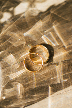 wedding rings on a wooden background