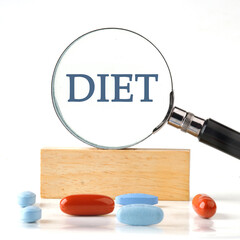 Diet and Healthy food concept. DIET written it manifested itself in a magnifying glass standing on...