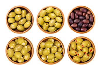 Pickled large olives in wooden bowls. Top row whole green olives with pit, pitted, and purple...