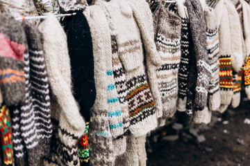 Warm knitted socks with pattern sold on market. Gifts for winter holidays