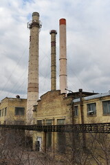 Exterior view of an old factory building with chimneys 