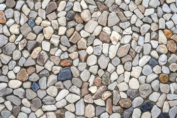 Colorful of pebbles on wall for abstract background and texture for interior or exterior design. Beautiful patterns, banner, wallpaper close up.