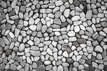Empty monochrome black and white (gray) embossed stone on cement wall for abstract background and texture for interior or exterior design. Beautiful patterns, banner, wallpaper close up.