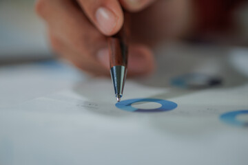 A businessperson gathers key data and prepares an annual performance summary, focusing on metrics, outcomes, and strategic insights