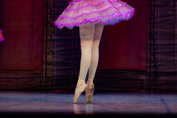 Closeup of ballerina dancing isolated on stage.