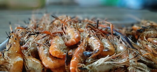Freshly Caught Shrimp Pile Ready for Seafood Preparation and Cooking in a Rustic Kitchen Setting