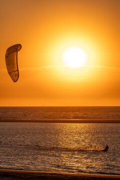Kiter at sunset in golden light