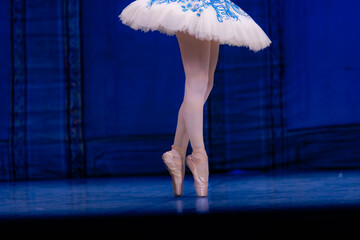 Closeup of ballerina dancing isolated on stage.