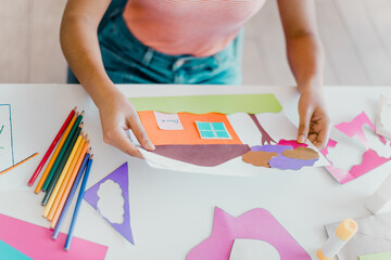 Creative home craft activity making colorful paper art indoors during daylight