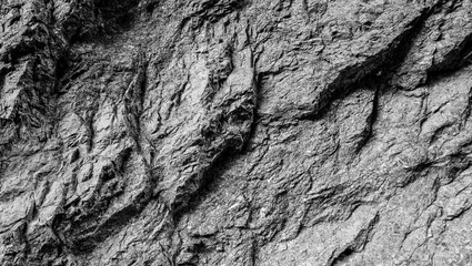 Empty grey stone wall on cave surface for abstract background and texture. Template for design, natural patterns, space for work, banner,seamless wallpaper, close up.