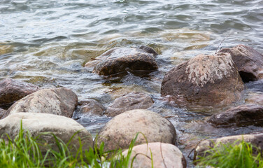 Landscape view of the lake with boulders in the foreground,