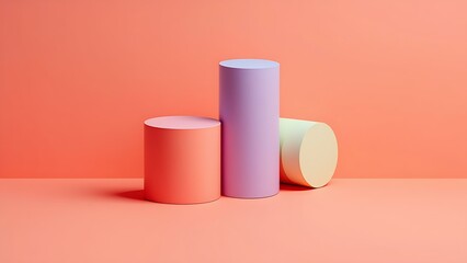 Pastel colored cylinders on coral background