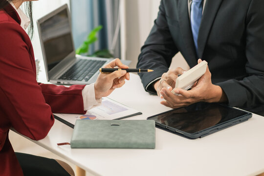 Businesswoman talking to business consultant to make decision on new business investment to make more productive and consultant also give advice on statistics on customer demand including good profit.