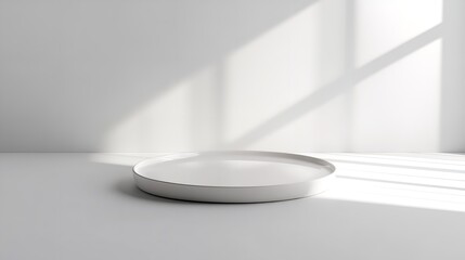 Minimalist white platform surrounded by elegant drapery and soft light in a modern interior space