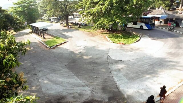 Time lapse footage of the activites on the Pool Shelter of Public Bus transportation in Jakarta, Indonesia. Public buses arriving and departing along the lane