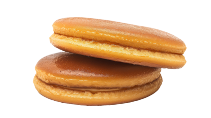 Two golden-brown cookies stacked on top of each other with a soft texture