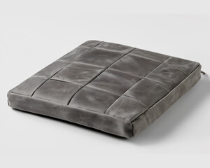 Gray leather seat cushion resting on white background