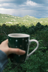 Morning coffee against the backdrop of an incredible peaceful mountain landscape