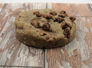 Chocolate chip cookies on a wooden board with a white background