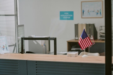 Obraz premium Interior of visa application center being depicted with tables, chairs, and American flag, highlighting organized and professional environment