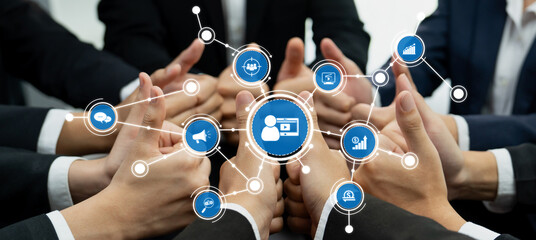 Hands of diverse business professionals join together, surrounded by digital icons representing marketing and strategy, highlighting collaboration and teamwork in a modern environment. Amity