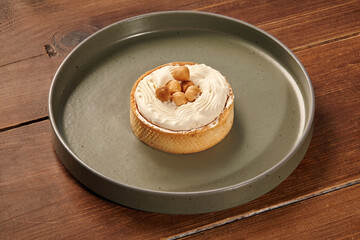 Delicious hazelnut cake on a green plate sitting on wooden table