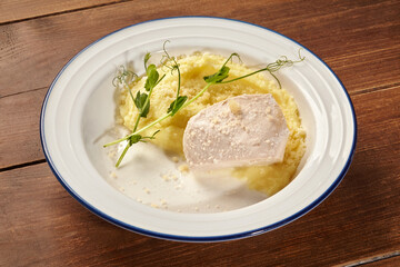 Chicken breast with mashed potatoes and pea sprouts on elegant plate