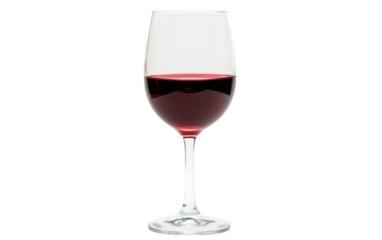 Glass of red wine is sitting on a table