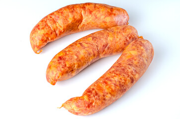 Three raw smoked sausages on white background in studio lighting for food packaging, advertising, and culinary use
