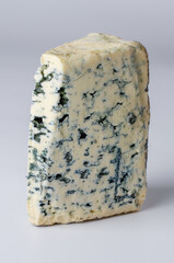 Piece of blue mold cheese standing on white background for culinary use, packaging design, advertising and recipe illustration