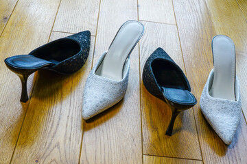 Elegant Black and Silver High Heel Mules with Sequin Details Displayed on a Wooden Floor in Daylight