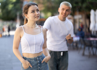 Obraz premium Young girl squabble with partner about jealousy. Husband and wife quarrel during walk, make accusations, bicker. Person tries to engage offended interlocutor in conversation..