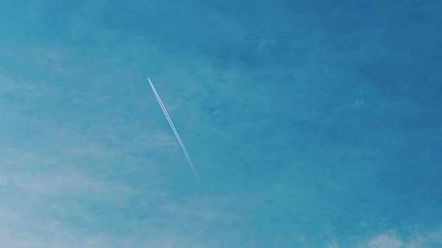 Flying Jet with smoke over on SKY blue background.
A jet with ejecting smoke behind the blue Cloudy SKY background 