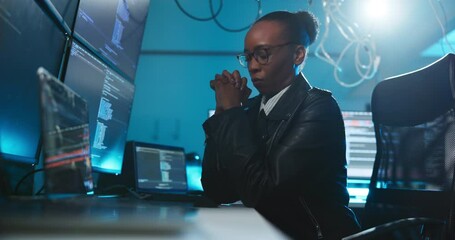Night, computer or black woman with cyber security, coding and malware error with software update. African person, programmer and employee in workplace, pc or evening with hacker and IT technician