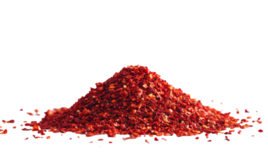Pile of red pepper flakes on a white background