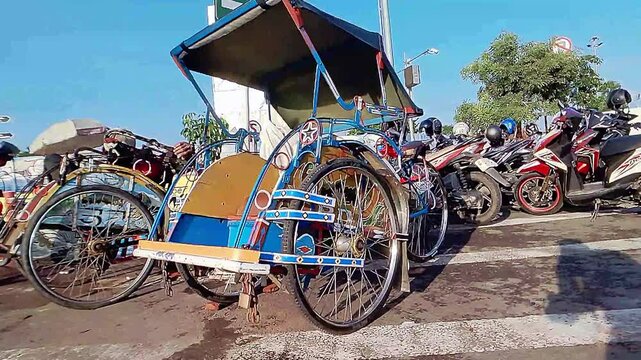 Cinematic shot of a colorful vibrant paintings decorated rickshaw existingly parked among motorcycles. Old School transportation&nbsp;mode&nbsp;concept