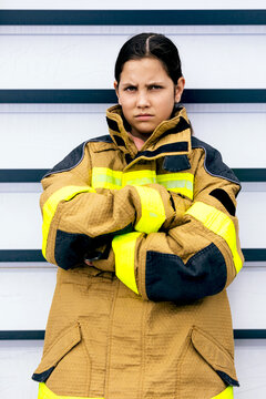 Girl wearing firefighter suit with determined expression