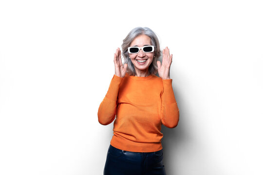 Asian old lady in vibrant orange sweater with white sunglasses