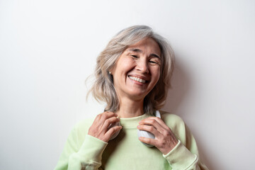 Happy asian senior woman with headphones