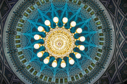 Majestic interior dome of Sultan Qaboos Mosque in Muscat, Oman
