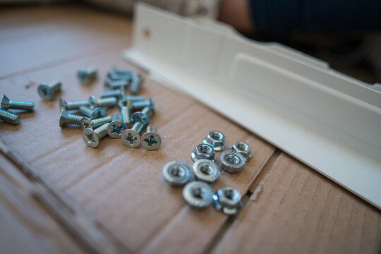 Close-Up of Screws and Nuts During White Desk Assembly
