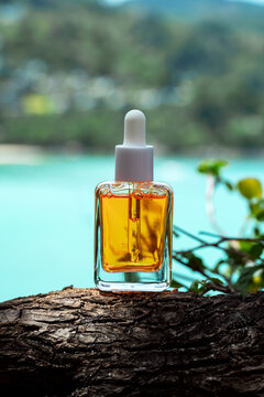 Cosmetic serum with vitamins and golden flakes by the seaside