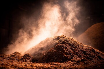 A warm kitchen filled with aromatic spices showcases a mound of freshly ground spices. Soft light...