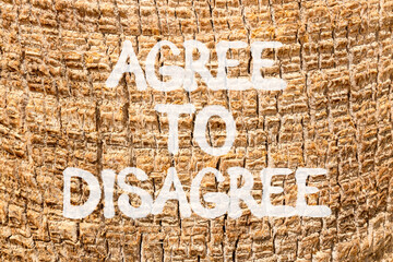 Agree to disagree symbol. Concept words Agree to disagree on beautiful palm bark. Beautiful palm...